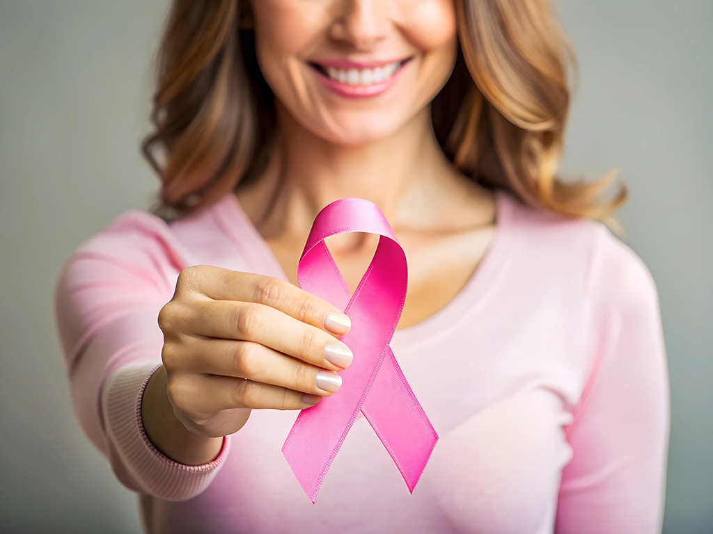 Woman holding pink ribbon, breast cancer awareness, pink october concept. Selective focus on pink ribbon. Pink October is Cancer Awareness Month.